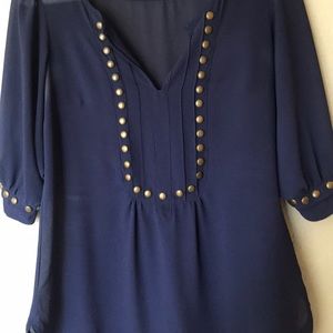 Navy blouse with studded detail.